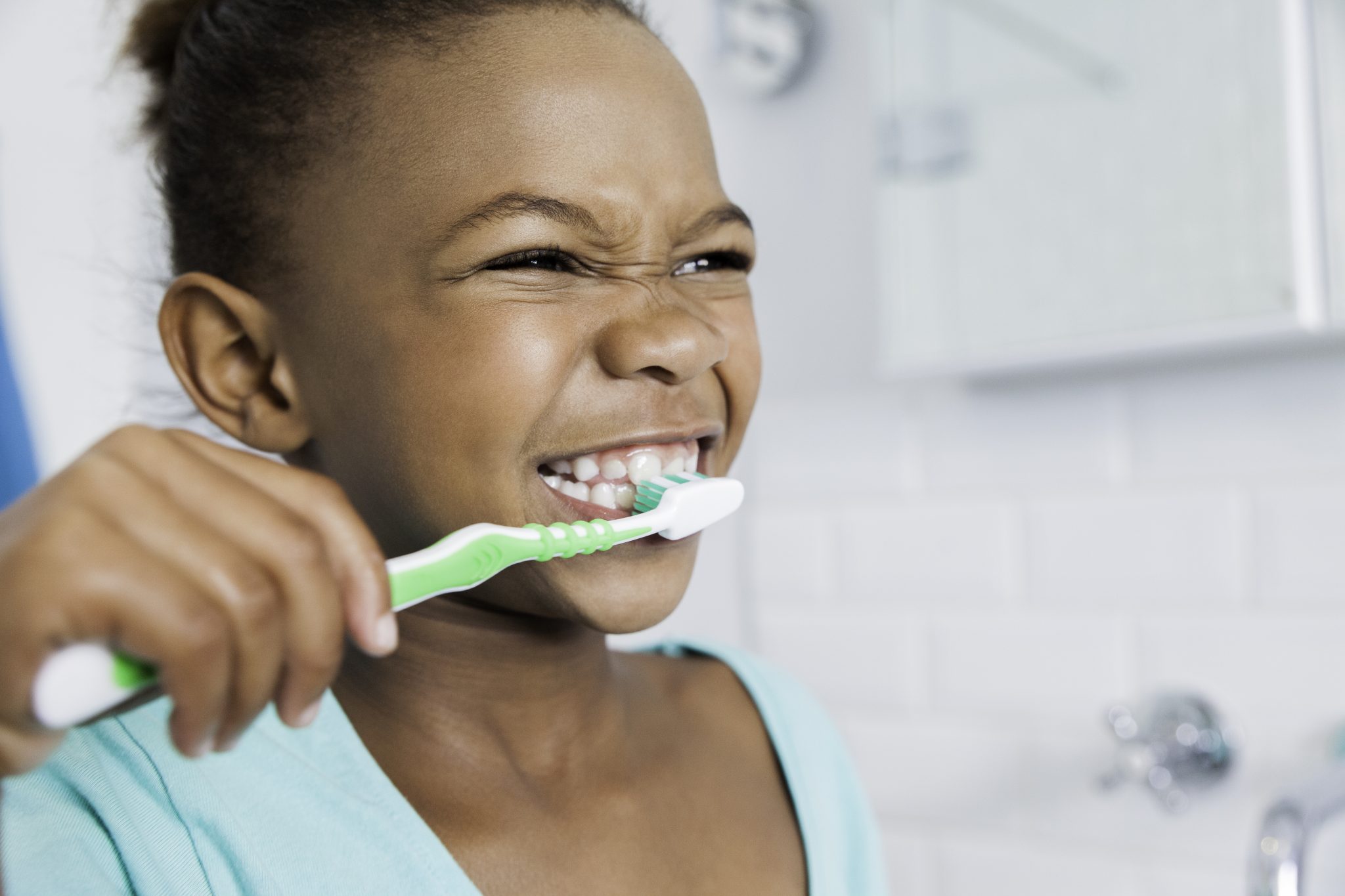 Beautiful young girl brushing her teeth. 815356714 5616x3744 scaled 1